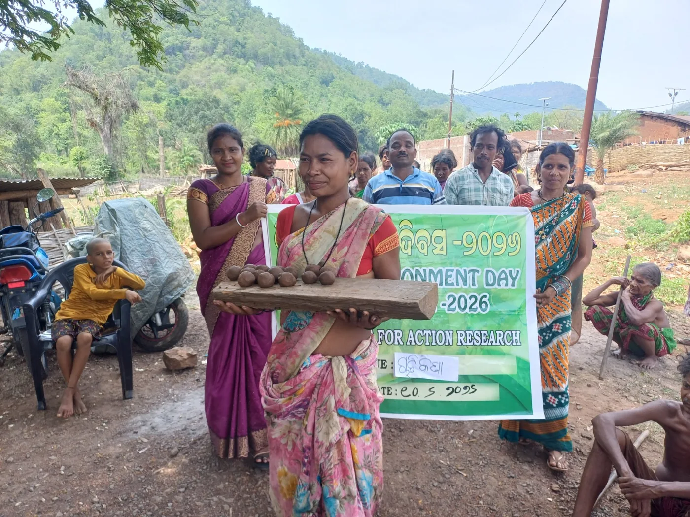 Community members taking part in an environmental awareness activity and seed-ball regeneration.
